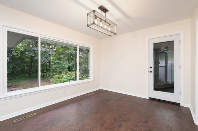 unfurnished dining area with dark hardwood / wood-style floors