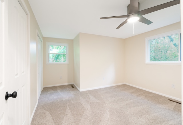 empty room with light colored carpet and ceiling fan