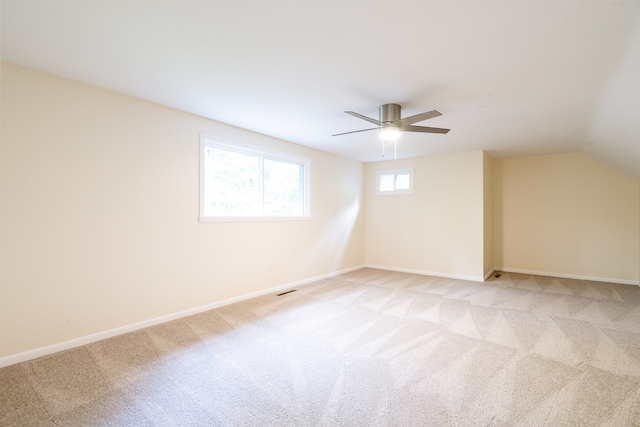 bonus room featuring ceiling fan, light colored carpet, and vaulted ceiling