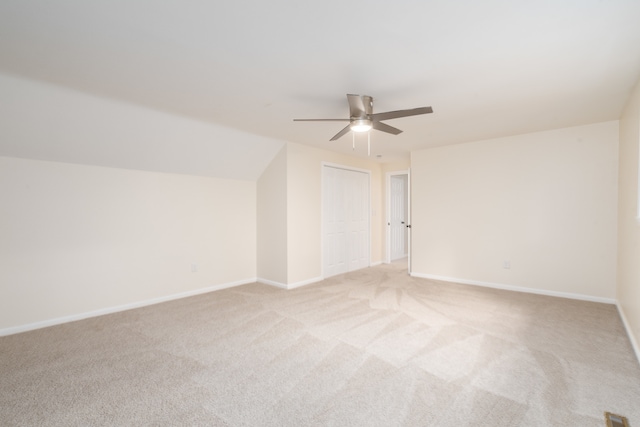 bonus room with ceiling fan, light carpet, and lofted ceiling