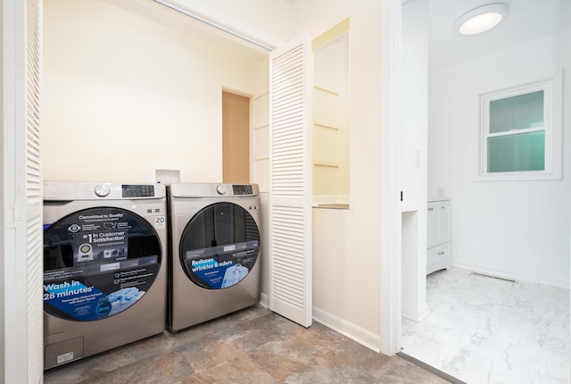 clothes washing area featuring independent washer and dryer