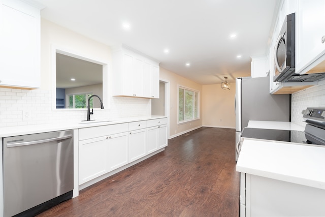 kitchen featuring white cabinets, a wealth of natural light, stainless steel appliances, and sink