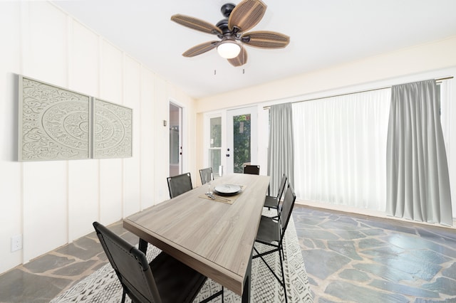 dining area featuring ceiling fan and french doors