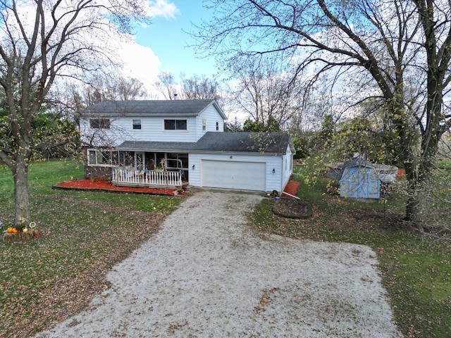 view of front of property with covered porch, a garage, a storage unit, and a front yard