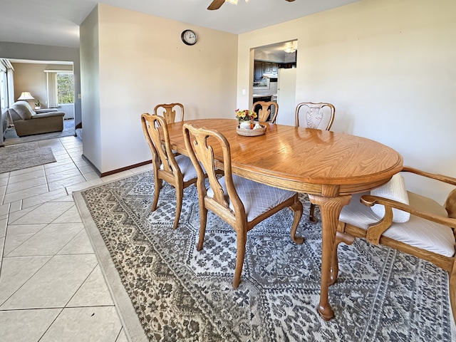 tiled dining area with ceiling fan