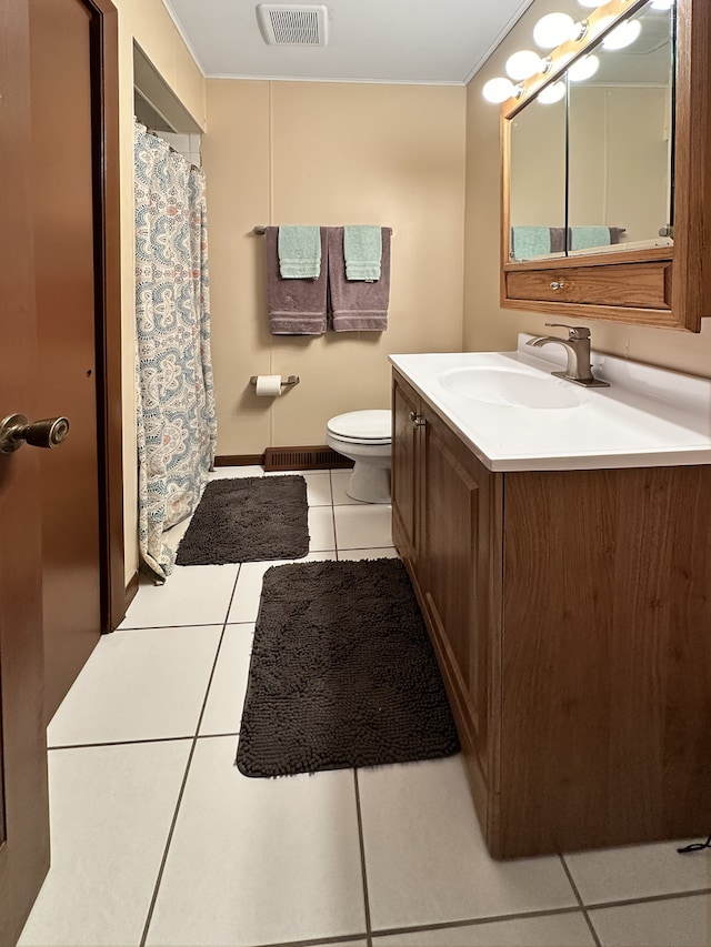 bathroom featuring tile patterned flooring, vanity, and toilet