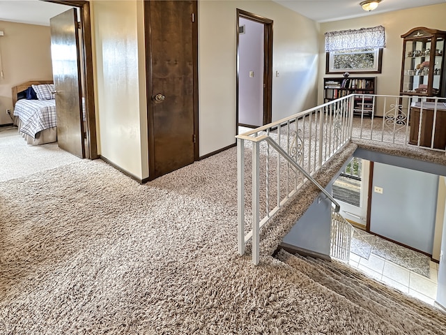 stairway featuring carpet