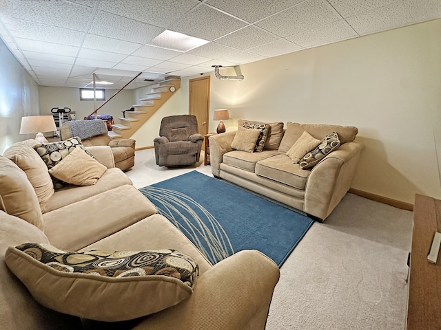 carpeted living room with a paneled ceiling