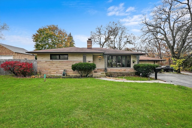 ranch-style home with a front lawn