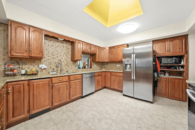 kitchen with light stone countertops, tasteful backsplash, stainless steel appliances, sink, and light tile patterned floors