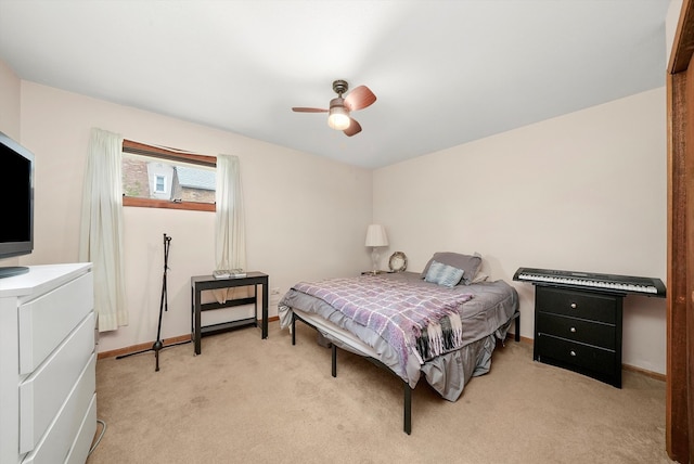 bedroom featuring light carpet and ceiling fan