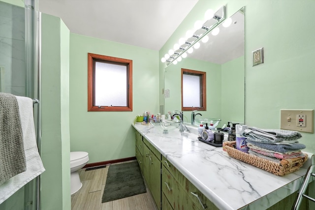 bathroom featuring wood-type flooring, vanity, and toilet