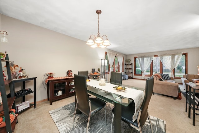 dining room featuring light carpet and an inviting chandelier