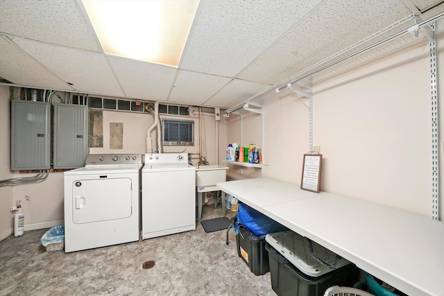 clothes washing area with washer and clothes dryer and electric panel