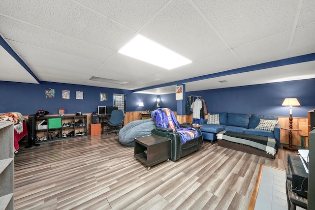 interior space with hardwood / wood-style floors and a drop ceiling