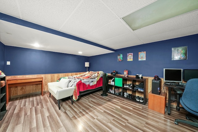 bedroom with hardwood / wood-style floors and a drop ceiling