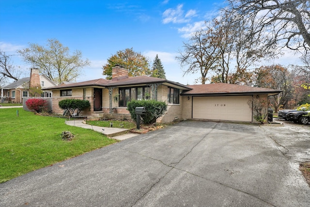 ranch-style home with a front yard and a garage