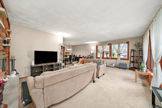 living room featuring carpet and a notable chandelier