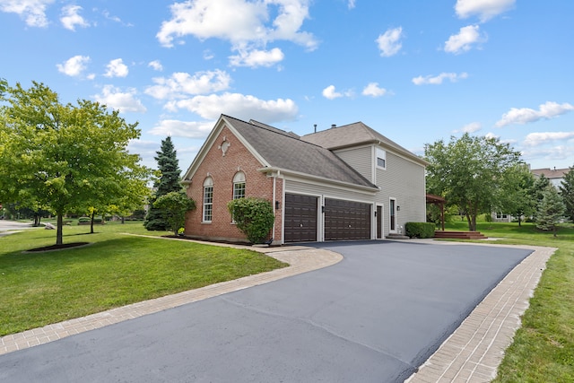 view of front of house with a garage and a front yard