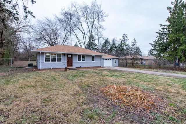 ranch-style house featuring a garage and a front lawn