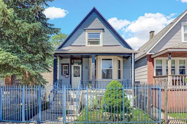 10456 S S Ave L, Chicago, IL 60617 - view of front of house featuring covered porch, a fenced front yard, a gate, and roof with shingles