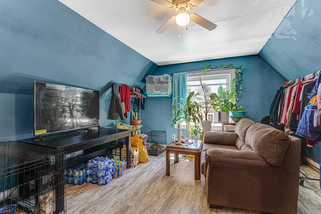 living room with hardwood / wood-style flooring, ceiling fan, and lofted ceiling