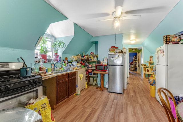 kitchen with lofted ceiling, dark brown cabinetry, light hardwood / wood-style flooring, ceiling fan, and appliances with stainless steel finishes