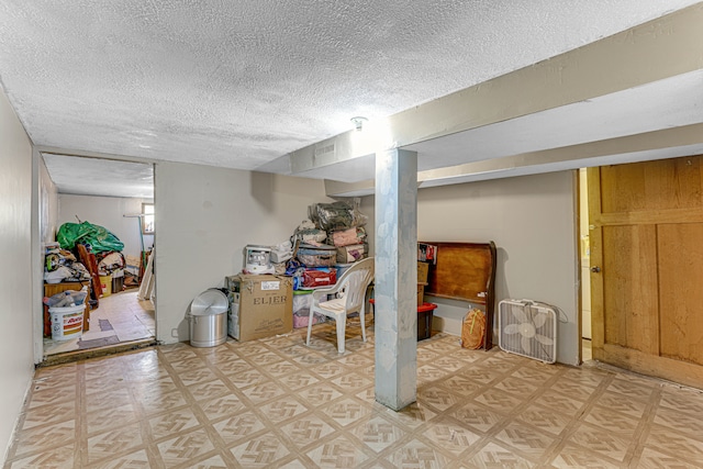 basement featuring a textured ceiling