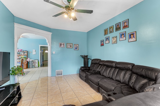 tiled living room with ceiling fan