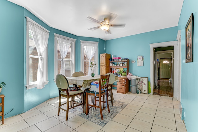 dining area featuring ceiling fan and light tile patterned floors