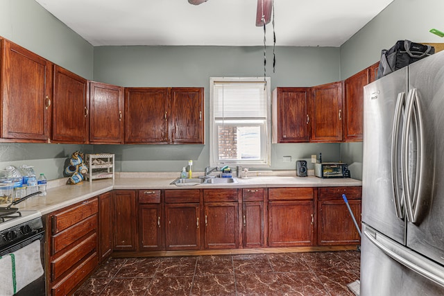 kitchen with sink, white range oven, and stainless steel fridge