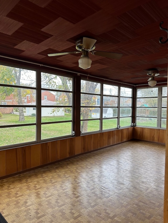 unfurnished sunroom with ceiling fan