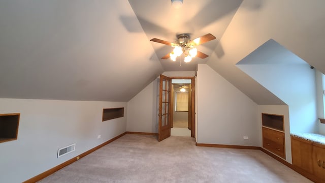 additional living space featuring ceiling fan, light carpet, and vaulted ceiling