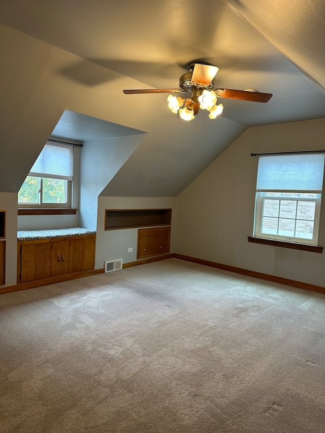 additional living space with ceiling fan, carpet floors, and vaulted ceiling