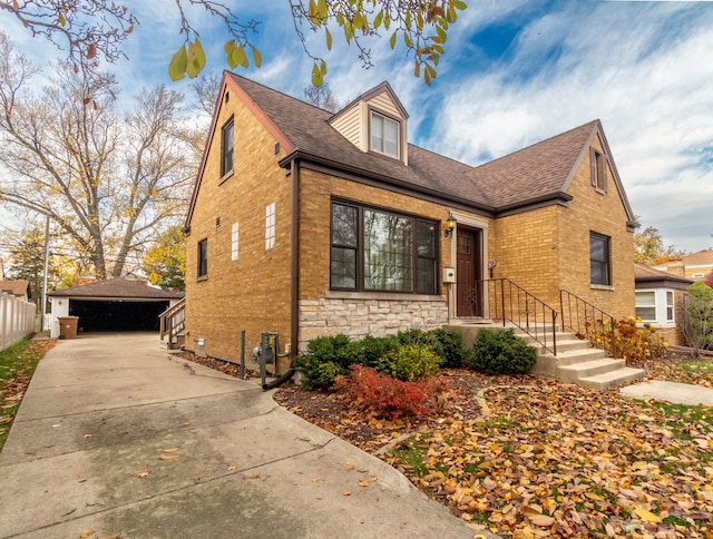 view of front of property with a garage and an outdoor structure