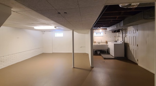 basement featuring sink and independent washer and dryer