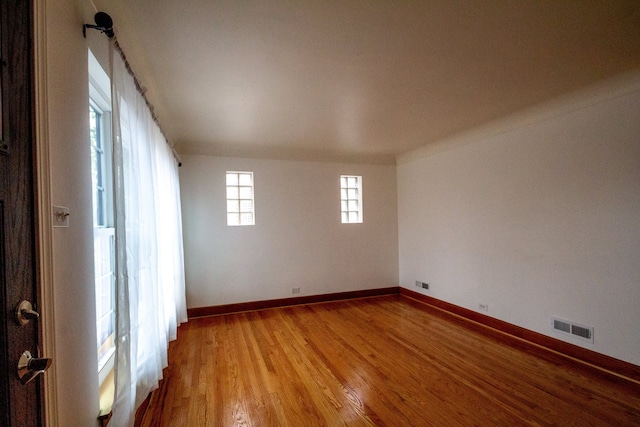 unfurnished room with hardwood / wood-style floors