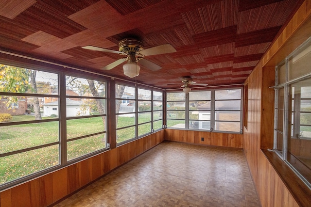 unfurnished sunroom featuring ceiling fan