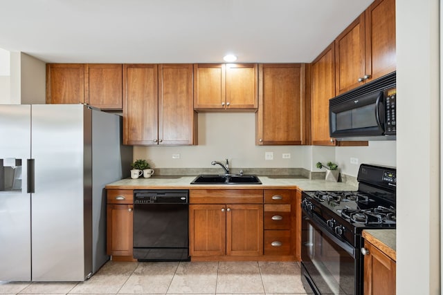 kitchen with sink, light tile patterned floors, and black appliances