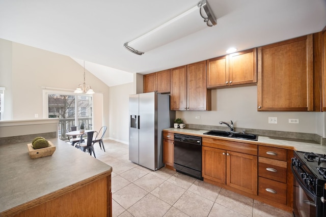 kitchen with sink, light tile patterned floors, lofted ceiling, black appliances, and decorative light fixtures