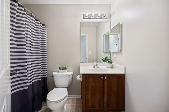 bathroom featuring tile patterned floors, vanity, and toilet