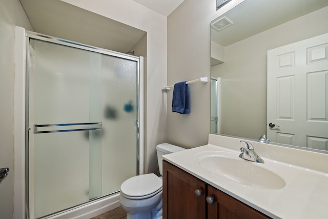 bathroom featuring toilet, vanity, and walk in shower