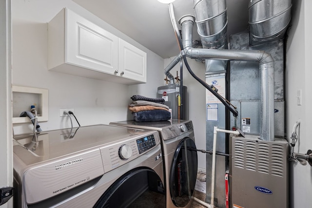 laundry room featuring washer and dryer, cabinets, and gas water heater