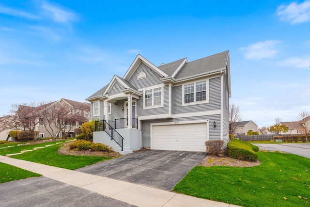 view of front of home with a garage and a front lawn