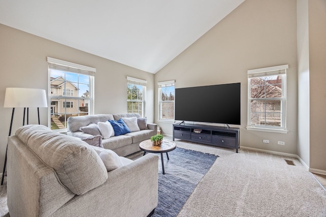 living room with light carpet and high vaulted ceiling