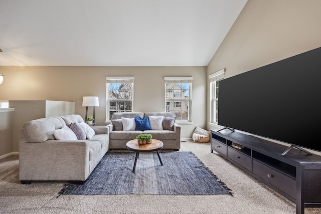 carpeted living room featuring high vaulted ceiling