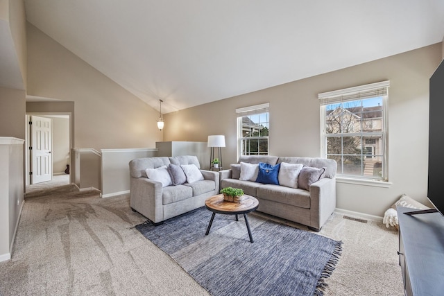 carpeted living room featuring high vaulted ceiling