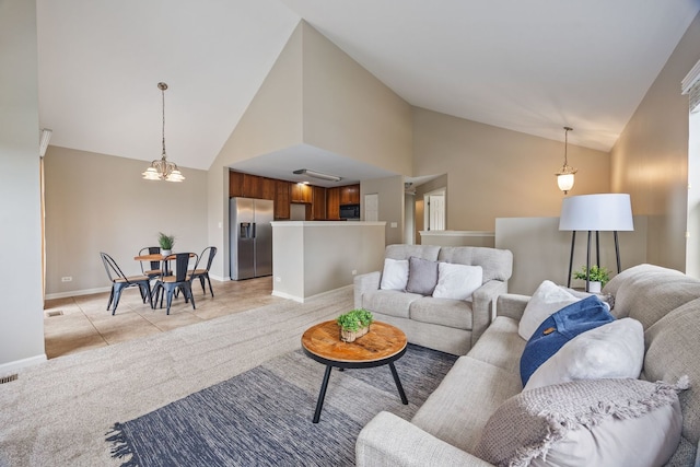 tiled living room featuring high vaulted ceiling and a notable chandelier