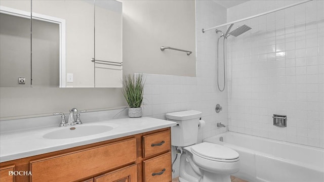 full bathroom featuring vanity, toilet, and tiled shower / bath combo