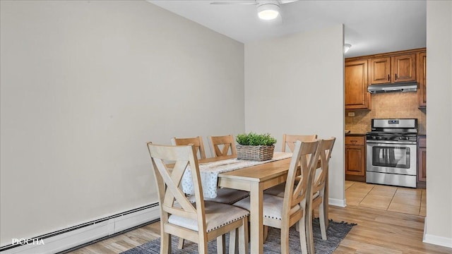 dining space featuring light hardwood / wood-style flooring, a baseboard radiator, and ceiling fan